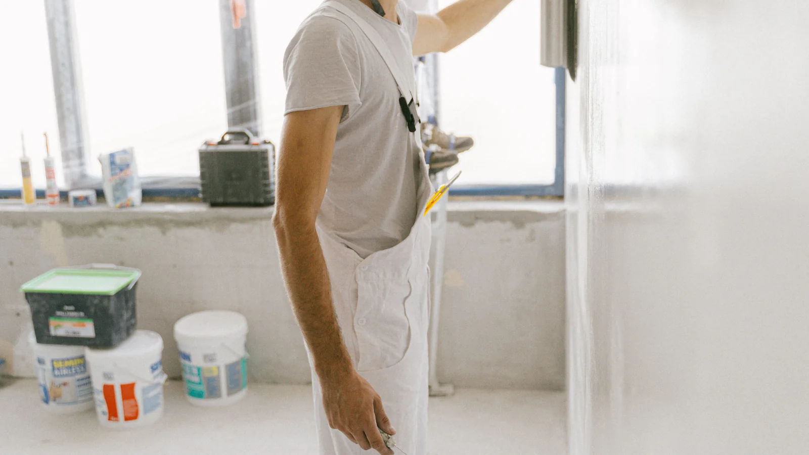 Stucco crew applying a new wall finish during a full re-stucco and recoat project